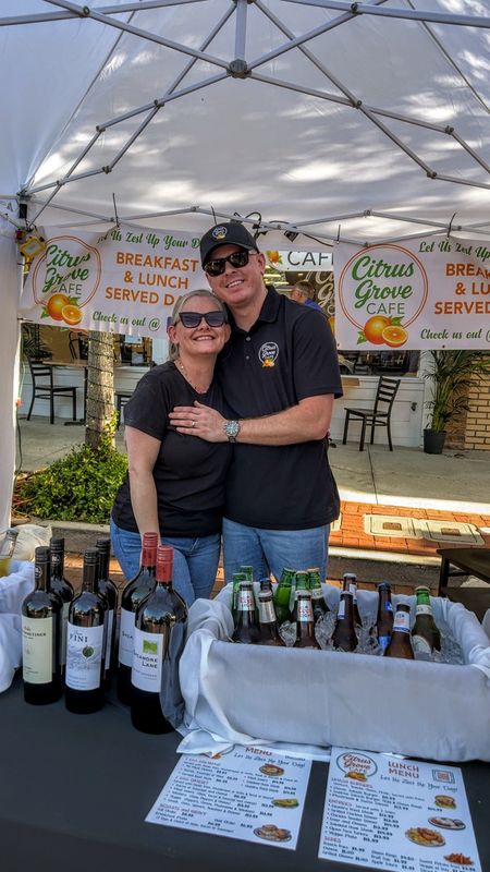 Julie Sheehan and Bjarki Bjornsson, owners of Citrus Grove Cafe in Eustis, set up outside their establishment just days after opening for the First Friday street celebration in Eustis, on April 3, 2026.