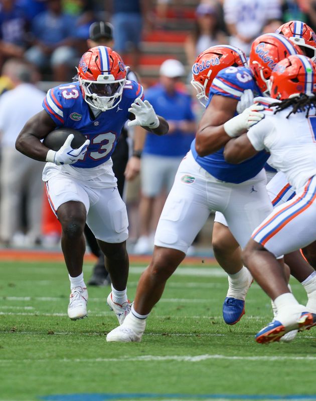 Florida running back Jadan Baugh (13) runs during the first half of the Orange and Blue game at Steve Spurrier Field at Ben Hill Griffin Stadium in Gainesville, FL on Saturday, April 11, 2026. [Alan Youngblood/Gainesville Sun]