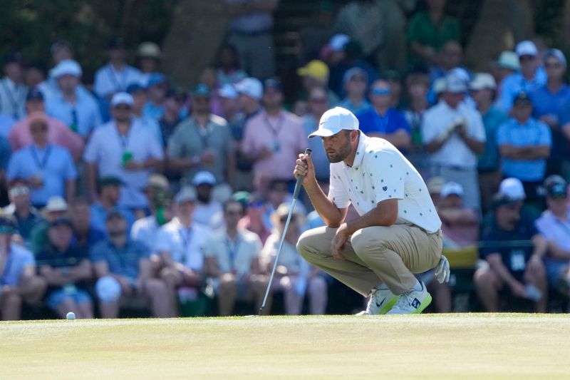 Apr 11, 2026; Augusta, Georgia, USA; Scottie Scheffler lines up his putt on the 15th green during the third round of the Masters Tournament at Augusta National Golf Club. Mandatory Credit: Kyle Terada-Imagn Images