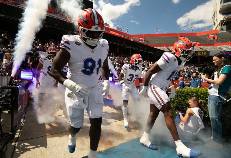 Florida blasts out onto the field during the second half of the Orange and Blue game at Steve Spurrier Field at Ben Hill Griffin Stadium in Gainesville, FL on Saturday, April 11, 2026. [Alan Youngblood/Gainesville Sun]