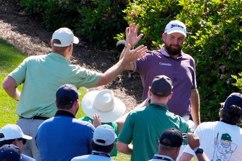 Apr 11, 2026; Augusta, Georgia, USA; Shane Lowry high fives patrons after hitting a hole-in-one on the sixth hole during the third round of the Masters Tournament at Augusta National Golf Club. Mandatory Credit: Katie Goodale-Imagn Images