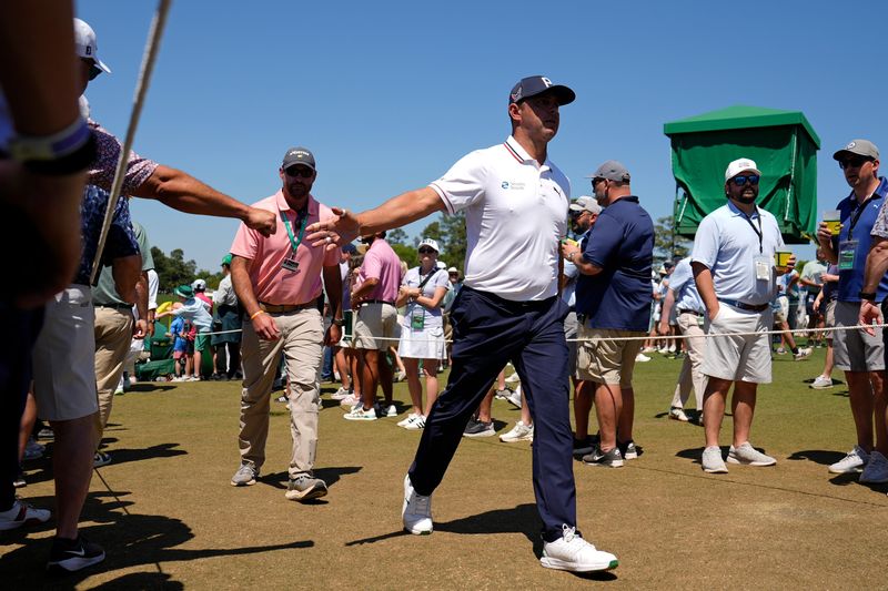 Apr 11, 2026; Augusta, Georgia, USA; Gary Woodland and his security walks to the 10th tee during the third round of the Masters Tournament at Augusta National Golf Club. Mandatory Credit: Katie Goodale-Imagn Images