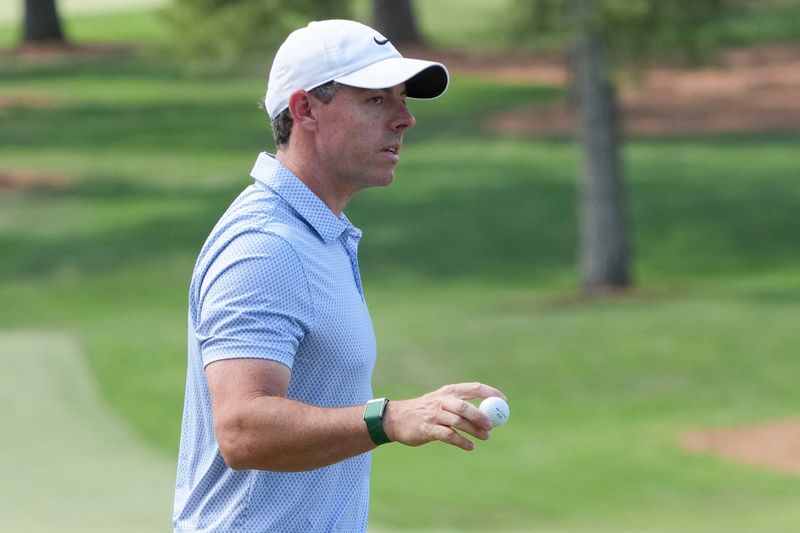 Apr 12, 2026; Augusta, Georgia, USA; Rory McIlroy holds up his ball after putting for a birdie on the seventh green during the final round of the Masters Tournament at Augusta National Golf Club. Mandatory Credit: Michael Madrid-Imagn Images