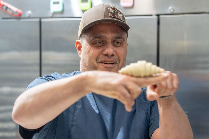 Nelson Omana, co-owner of Le Point Pastry & Bakery, prepares croissants ahead of the grand opening of the All Saints location, Monday, April 13, 2026.