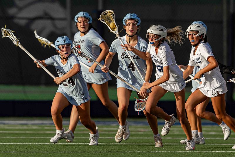 Ava Fortnam (22) carries the ball upfield as the American Heritage School Stallions hosted the Saint John Paul II Academy Eagles in Florida High School Athletic Association girls varsity lacrosse action at the Scott Maurer Memorial Stadium on their campus in unincorporated Palm Beach County, Fla., on April 13, 2026. The Stallions dominated the Eagles in a 20-4 win.
