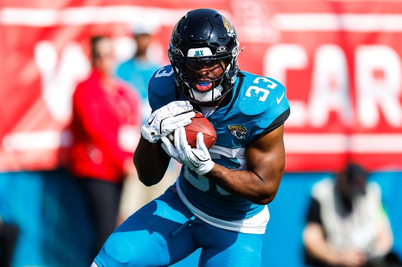 Jacksonville Jaguars running back Bhayshul Tuten (33) returns a kick off return during the first quarter in an NFL football AFC Wild Card playoff matchup, Sunday, Jan. 11, 2026, in Jacksonville, Fla. Bills lead 10-7 at the half over the Jaguars. [Doug Engle/Florida Times-Union]
