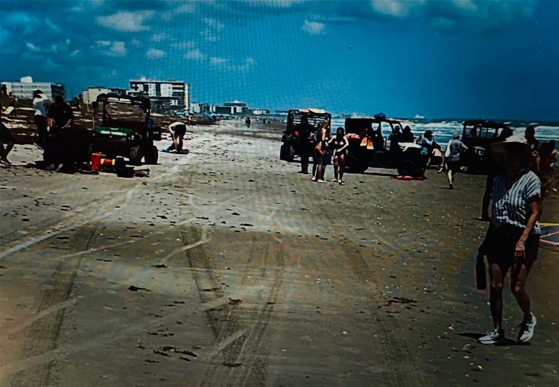 Lifeguards work to revive two adults pulled from waves at Cocoa Beach on Tuesday, April 14.