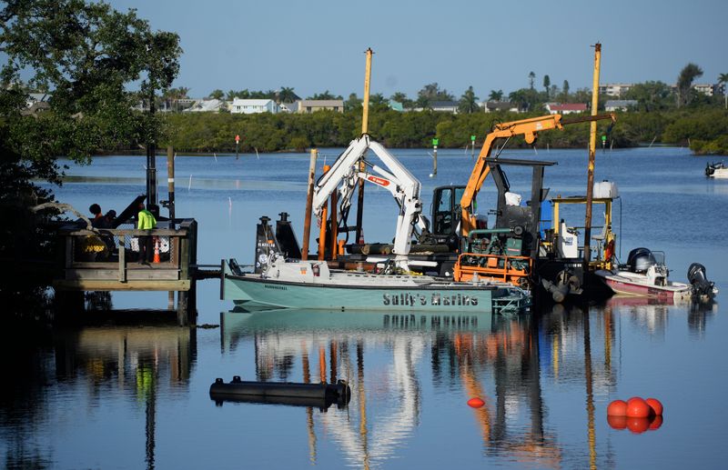 Most of the dredging near the mouth of Phillippi Creek is expected to be hydraulic dredging using pumps instead of mechanical dredging with buckets. Workers have positioned dredging equipment along Phillipi Estate Park on Phillippi Creek as they prepare for the next phase of dredging the creek.