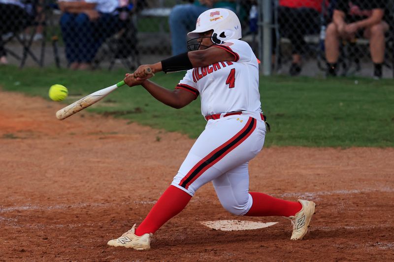 Baker County's Nasia Green (4) hits a grand slam home run during the sixth inning of a high school softball matchup at Baker County High School, Tuesday, April 14, 2026, in Glenn St. Mary, Fla. The Baker County Wildcats rallied in the sixth inning to defeat the Middleburg Broncos 6-4.