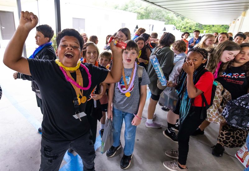 Fifth-grader Kingston Greenland, left, cheers as he lines up with his fellow classmates for the last day school at Belleview-Santos Elementary School in Marion County on May 26, 2023.