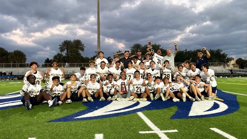 Boca Raton's boys lacrosse squad takes a celebratory trophy photo after defeating West Boca Raton on April 15, 2026.