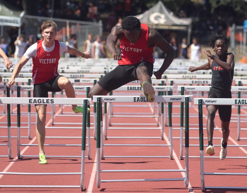 Victory Christian's Andrew Morrison win the 110 hurdles on Thursday at the Class 1A, District 10 track and field meet at George Jenkins High School.