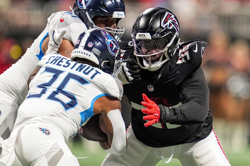 Aug 15, 2025; Atlanta, Georgia, USA; Atlanta Falcons defensive tackle Ruke Orhorhoro (98) tackles Tennessee Titans running back Julius Chestnut (36) at Mercedes-Benz Stadium. Mandatory Credit: Dale Zanine-Imagn Images