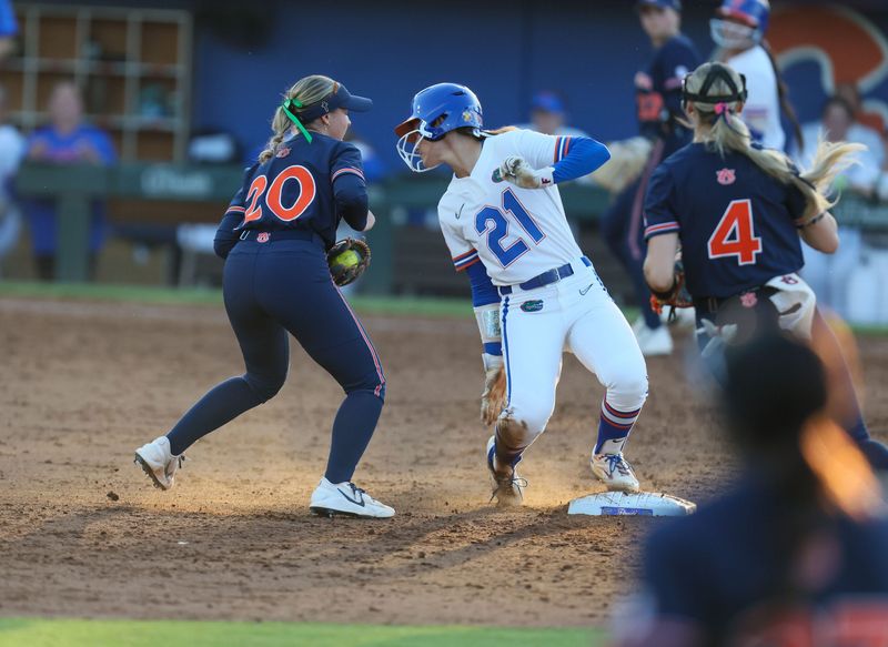 Auburn infielder Alyssa Hastings (20) misses tags Florida outfielder Taylor Shumaker (21) out at second durning an NCAA softball game at Katie Seashole Pressly Stadium in Gainesville, FL on Friday, April 17, 2026. [Alan Youngblood/Gainesville Sun]