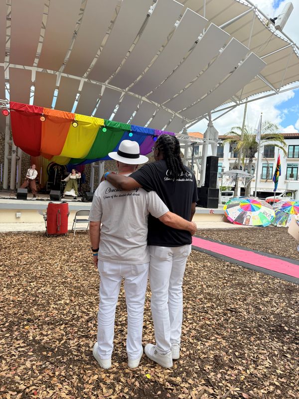 Vincent McCana and Reggie Little embrace as they watch the entertainment at Naples PrideFest Saturday, April 18, 2026.