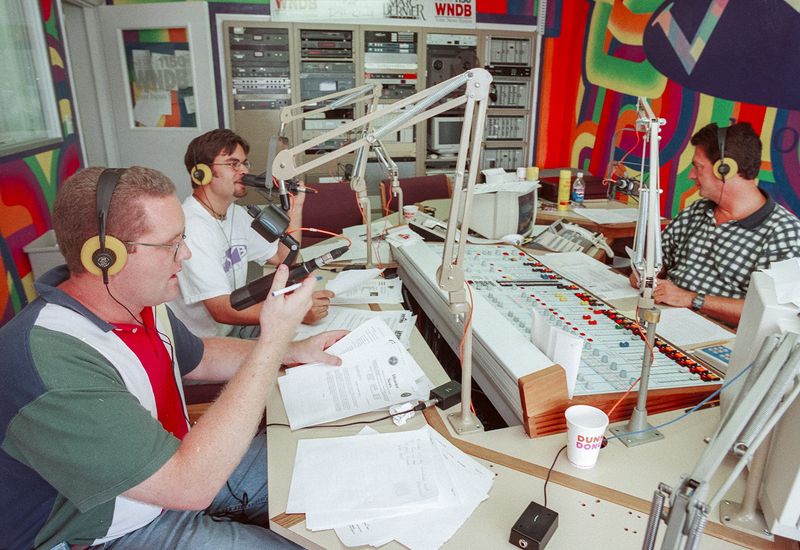 From left, WNDB news director Rory O'Neill, Tim Tuttle, VYB morning anchor, and Dave Laing, WNDB morning anchor, broadcast live on July 4, 1998, their third day continuous public service updates on the wildfires that were sweeping Volusia and Flagler Counties.