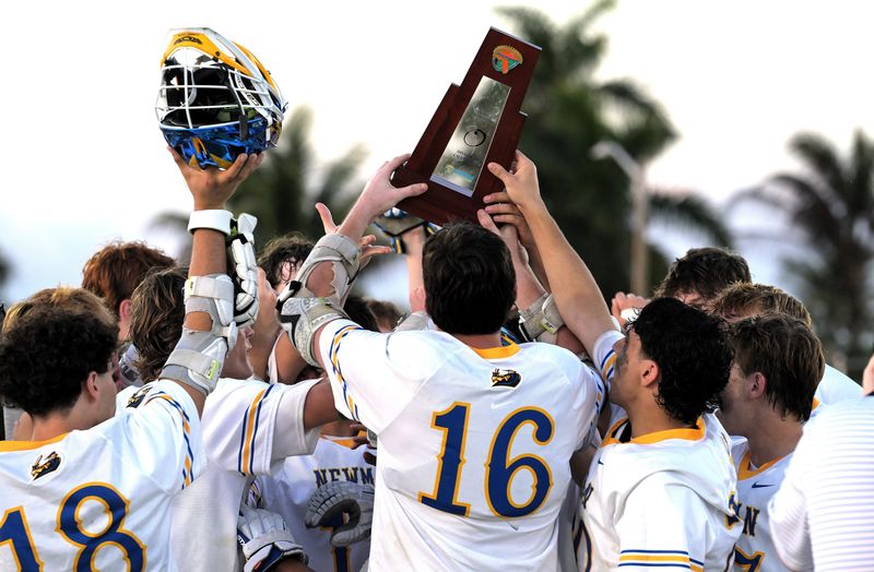 Cardinal Newman's lacrosse team with trophy after a 17-4 district championship victory against King's Academy on April 16, 2026.