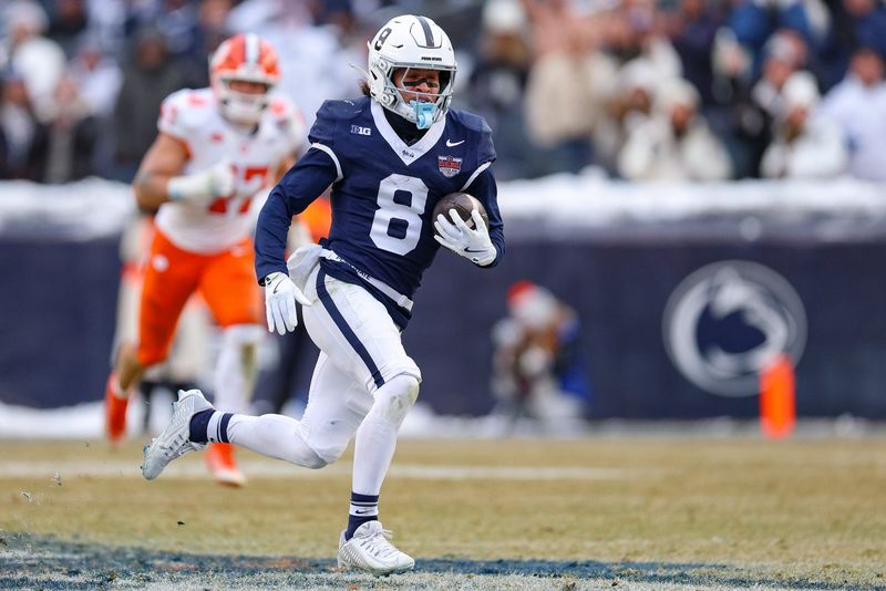 Dec 27, 2025; Bronx, NY, USA; Penn State Nittany Lions wide receiver Trebor Pena (8) scores a touchdown reception during the second half of the 2025 Pinstripe Bowl against the Clemson Tigers at Yankee Stadium. Mandatory Credit: Vincent Carchietta-Imagn Images