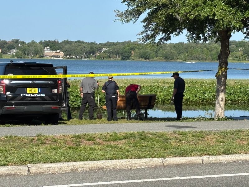 Lakeland police and maintenance work the scene where a body was found on the shore of Lake Hollingsworth the morning of April 20, 2026.