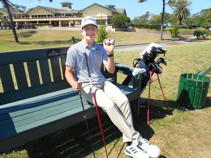 Josiah Foster of Jacksonville, 14, displays the balls and clubs he used to make two holes-in-one within a 19-day span, with the second on a par-4 hole at the Jacksonville Beach Golf Club.
