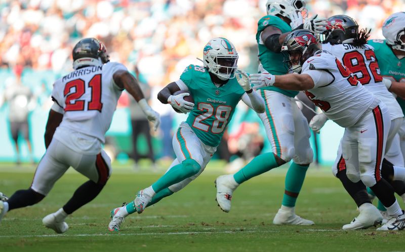 Dec 28, 2025; Miami Gardens, Florida, USA; Miami Dolphins running back De'Von Achane (28) runs for a gain during the second quarter against the Tampa Bay Buccaneers at Hard Rock Stadium. Mandatory Credit: Sam Navarro-Imagn Images