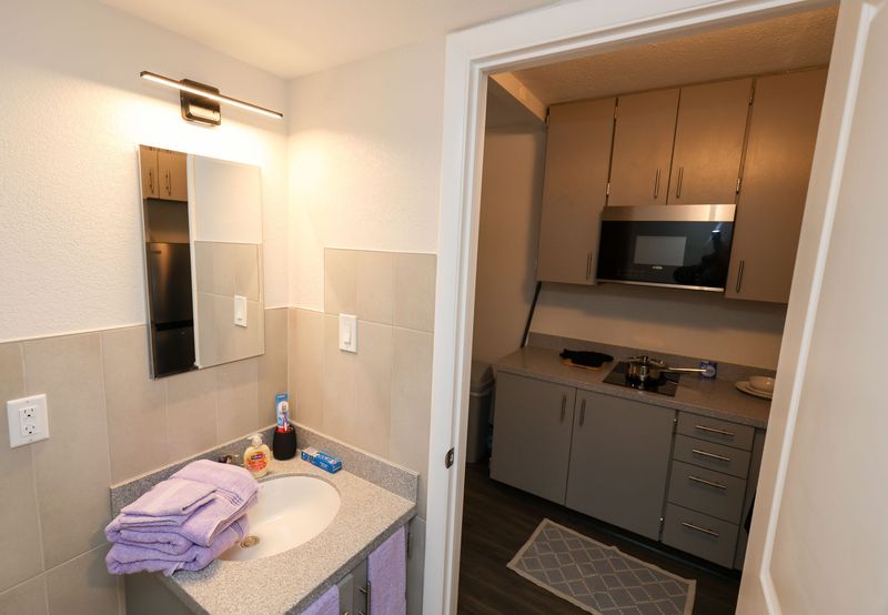 A bathroom inside a one-bedroom unit at East Tumblin Creek is shown during a tour following the ribbon-cutting for newly renovated permanent supportive housing in Gainesville, FL, on April 21, 2026.