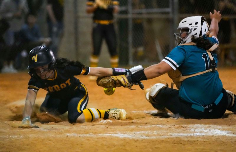 Gulf Coast Sharks catcher Hannah Rearden (16) applies a tag to Bishop Verot Vikings outfielder Willa Pagnutti (5) as Pagnutti tries to slide into home during the sixth inning of a game at Sam Fleishman Regional Sports Complex in Fort Myers, Fla., on Tuesday, April 21, 2026. The ball was knocked loose as the two made contact and umpires reversed the call from out to safe. The run tied the game 4-4.