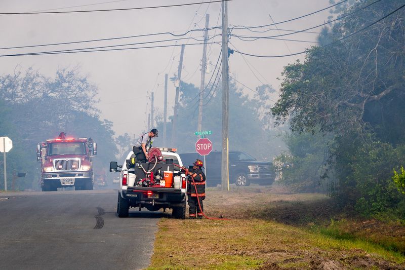 Firefighters battle a brush fire off on April 21, 2026, off of Britton Road in Lynn Haven, Florida.
