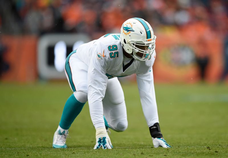 Nov 23, 2014; Denver, CO, USA; Miami Dolphins defensive end Dion Jordan (95) prepares to pass rush in the first quarter against the Denver Broncos at Sports Authority Field at Mile High. Mandatory Credit: Ron Chenoy-USA TODAY Sports