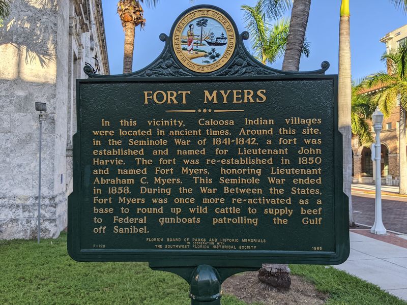 Photo by Mike Wintermantel /Provided by the Historical Marker Database 
This marker, at the intersection of First Street and Jackson Street, was erected in 1965. It reads: In this vicinity, Caloosa Indian villages were located in ancient times. Around this site, in the Seminole War of 1841-1842, a fort was established and named for Lieutenant John Harvie. The fort was re-established in 1850 and named Fort Myers, honoring Lieutenant Abraham C. Myers. This Seminole War ended in 1858. During the War Between the States, Fort Myers was once more re-activated as base to round up wild cattle to supply beef to Federal gunboats patrolling off Sanibel.