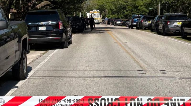 The Jacksonville Sheriff's Office cordons off Julington Creek Road for a police shooting on Wednesday.