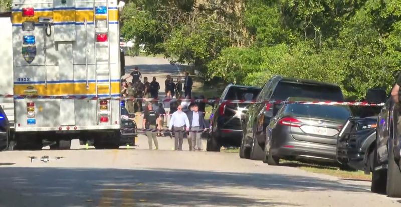 The Jacksonville Sheriff's Office cordons off Julington Creek Road for a police shooting Wednesday with the suspect killed.