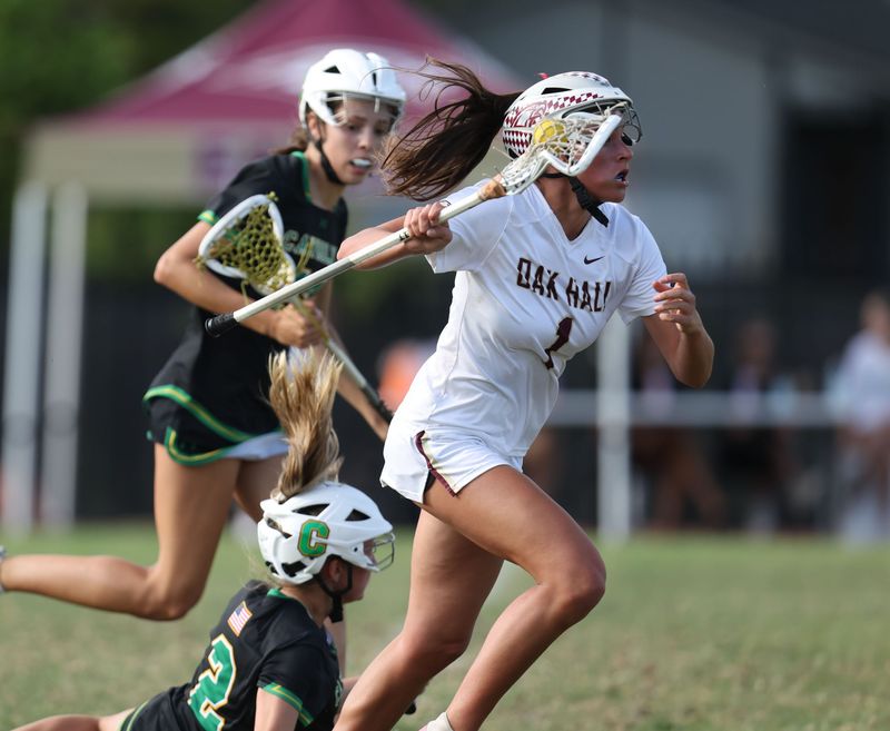 Oak Hall Raigan Trefzger (1) drives during an FHSAA girls lacrosse gamer at Oak Hall School in Gainesville, FL on Wednesday, April 22, 2026. [Alan Youngblood/Gainesville Sun]