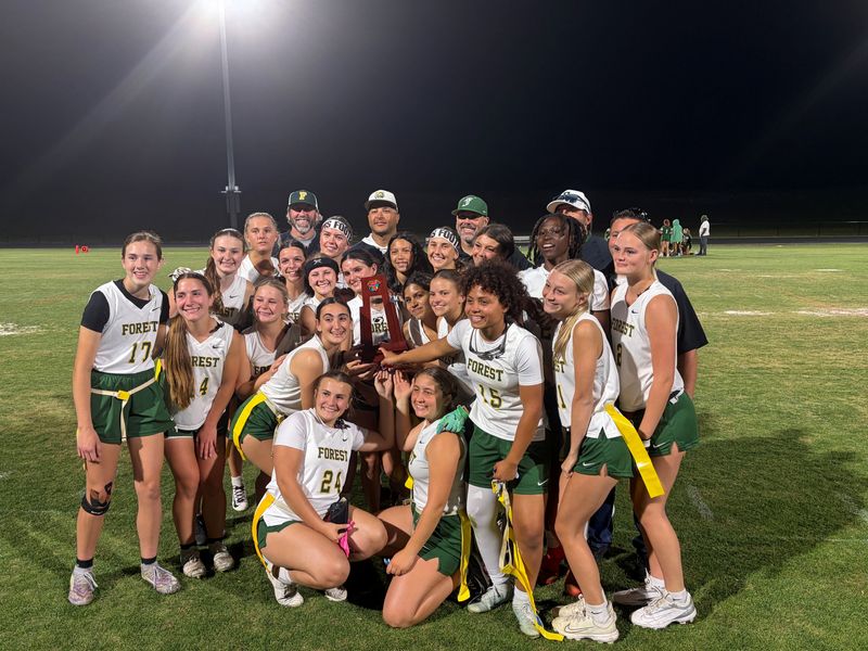 Forest's flag football team poses with the District 2-4A trophy after beating Flagler Palm Coast 26-7 for its first district title in school history on April 22, 2026, at University High School.