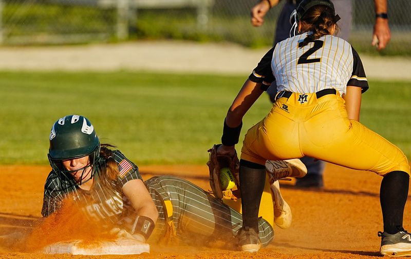 Lilly Rollinger of Melbourne Central Catholic slides into second before the tag by Elena Rollen of Merritt Island during their game April 22, 2026. Craig Bailey, FLORIDA TODAY via USA TODAY NETWORK
