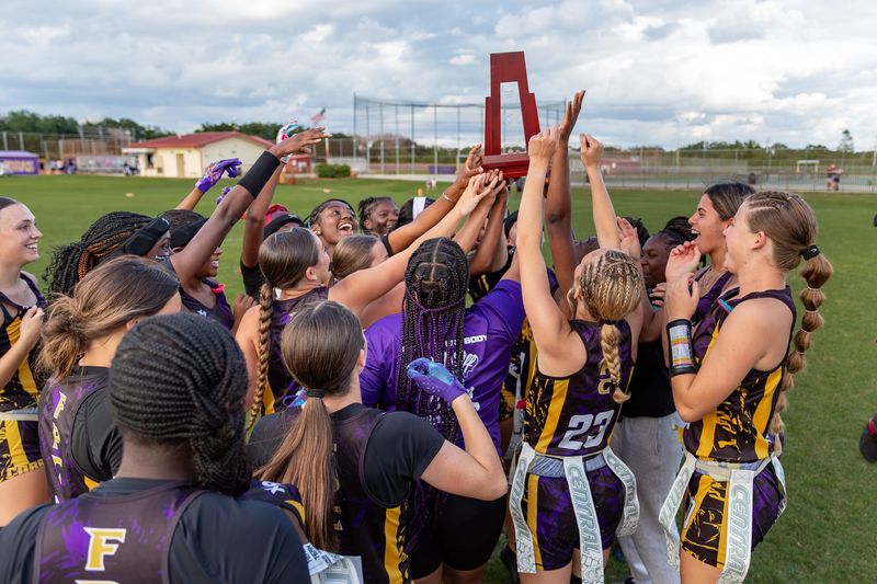 Fort Pierce Central players celebrate with the District 11-4A trophy after defeating Jupiter 20-6 on April 22, 2026, in Fort Pierce.