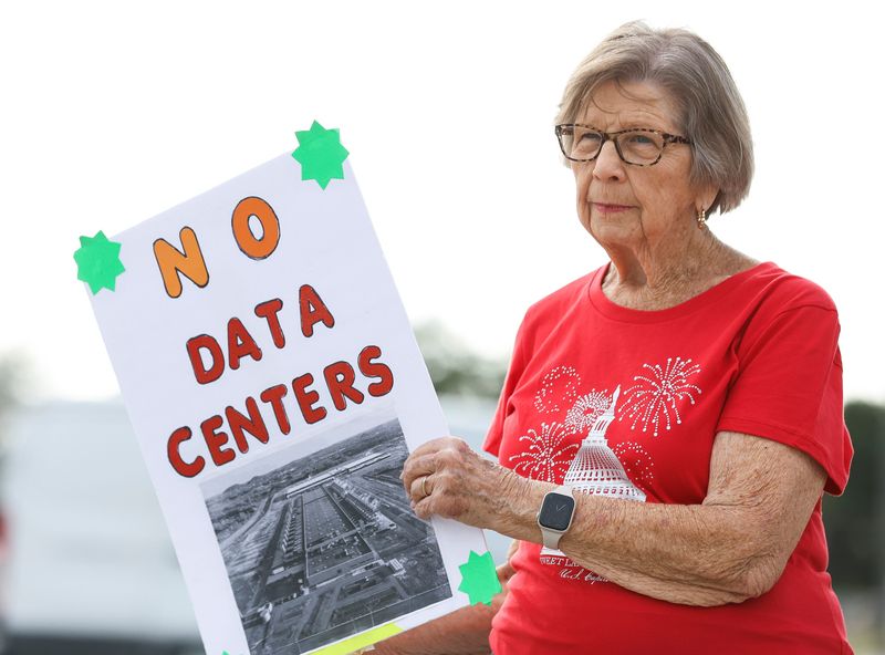 Residents against a data center in Indiantown stand on the corner of Warfield Boulevard and Southwest Adams Avenue before a regular council meeting, April 23, 2026. The Village Council took another step toward adopting an ordinance for a PUD zoning agreement and Master Site Plan and rezoning about 5,700 acres of FPL land that was annexed into the village. Opponents of the ordinance fear a data center could potentially be permitted. The ultimate approval of what gets built is decided with the village staff and not by the Village Council.