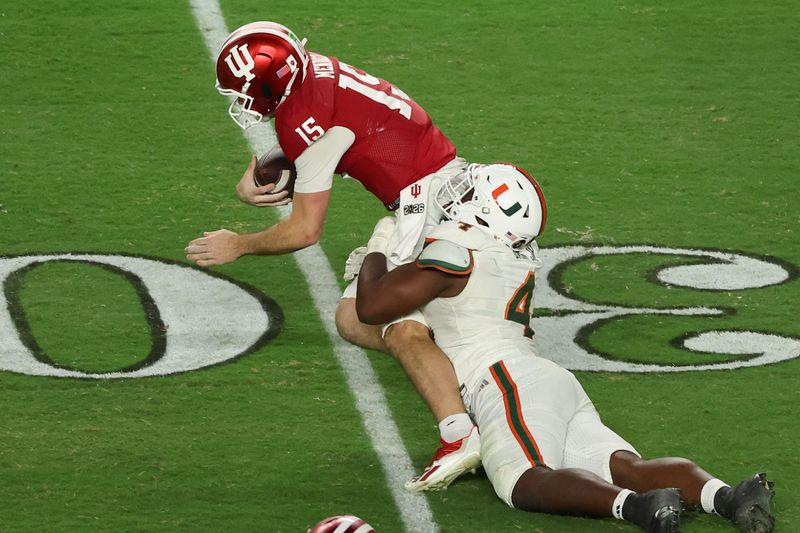 Jan 19, 2026; Miami Gardens, FL, USA; Miami Hurricanes defensive lineman Rueben Bain Jr. (4) sacks Indiana Hoosiers quarterback Fernando Mendoza (15) in the third quarter during the College Football Playoff National Championship game at Hard Rock Stadium. Mandatory Credit: Kim Klement Neitzel-Imagn Images