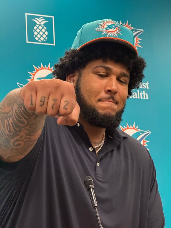 Miami Dolphins first-round draft pick Kadyn Proctor shows off his 1972 tattoo in honor of his stepfather.