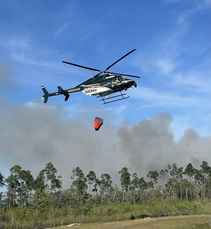 Another forest fire erupted on Friday off of County Road 2321 in Bay County. A Bay County Sheriff's Office helicopter was overhead, flying back and forth from the fire to a retention pond in the Titus Park Community, where it was retrieving water to dump on the blaze.