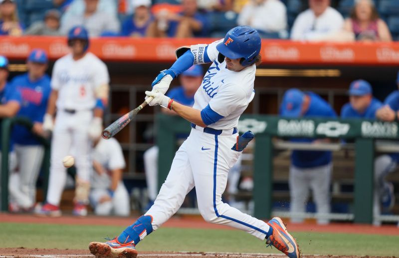 Florida infielder Brendan Lawson (11) hits during an NCAA baseball game at Condron Family Ballpark at Alfred A. McKethan Field in Gainesville, FL on Friday, April 24, 2026. [Alan Youngblood/Gainesville Sun]