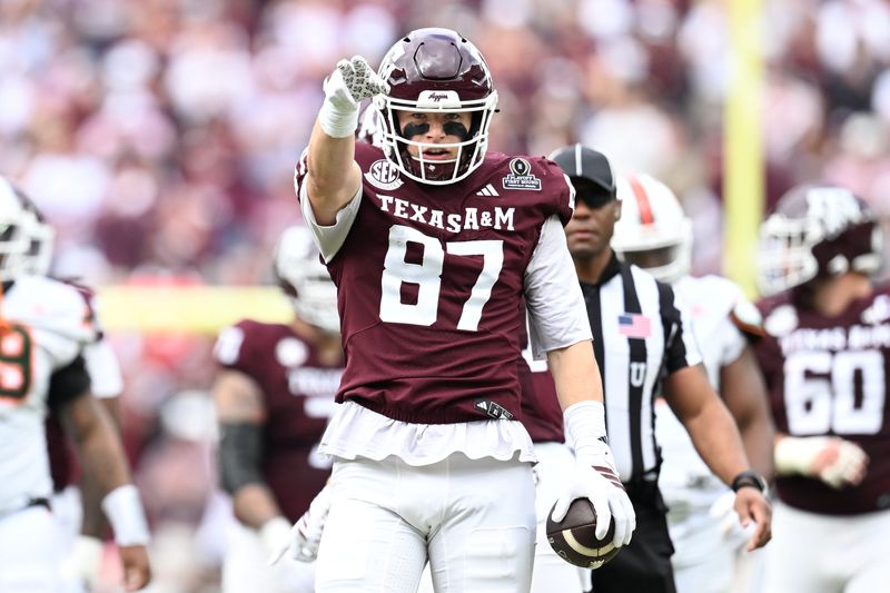 Dec 20, 2025; College Station, TX, USA; Texas A&M Aggies tight end Nate Boerkircher (87) celebrates a first down against the Miami Hurricanes during first quarter of the first round game of the CFP National Playoff at Kyle Field. Mandatory Credit: Maria Lysaker-Imagn Images