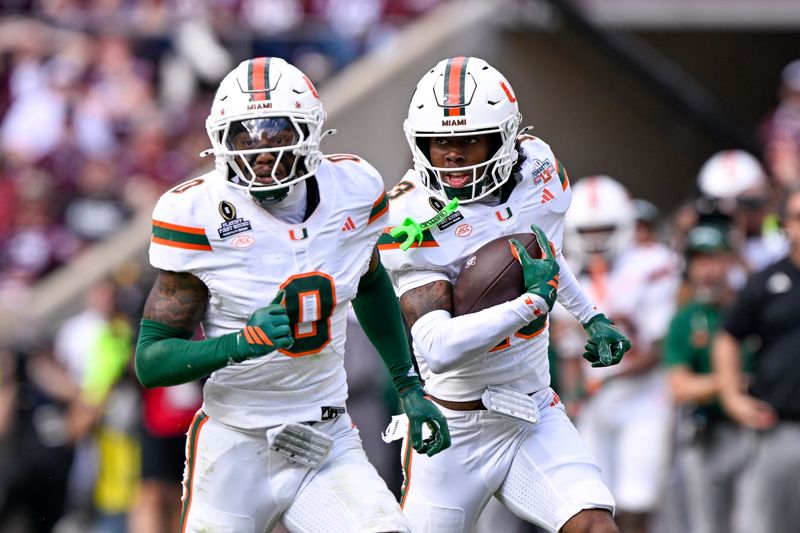 Dec 20, 2025; College Station, TX, USA; Miami Hurricanes defensive back Bryce Fitzgerald (13) returns an interception behind defensive back Keionte Scott (0) during the game between the Aggies and the Hurricanes at Kyle Field. Mandatory Credit: Jerome Miron-Imagn Images