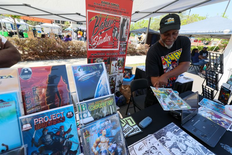 Gainesville comic book artist Terance Baker shows some of his work during the 46th annual 5th Ave Arts Festival at the Santa Fe College Blount Center on April 25 in Gainesville.