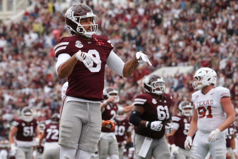 Oct 25, 2025; Starkville, Mississippi, USA; Mississippi State Bulldogs tight end Seydou Traore (8) does the “horns down” gesture after a touchdown during the second quarter against the Texas Longhorns at Davis Wade Stadium at Scott Field. Mandatory Credit: Petre Thomas-Imagn Images