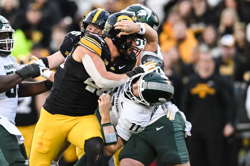 Nov 22, 2025; Iowa City, Iowa, USA; Iowa Hawkeyes defensive end Max Llewellyn (48) rushes Michigan State Spartans quarterback Alessio Milivojevic (11) during the second quarter at Kinnick Stadium. Mandatory Credit: Jeffrey Becker-Imagn Images