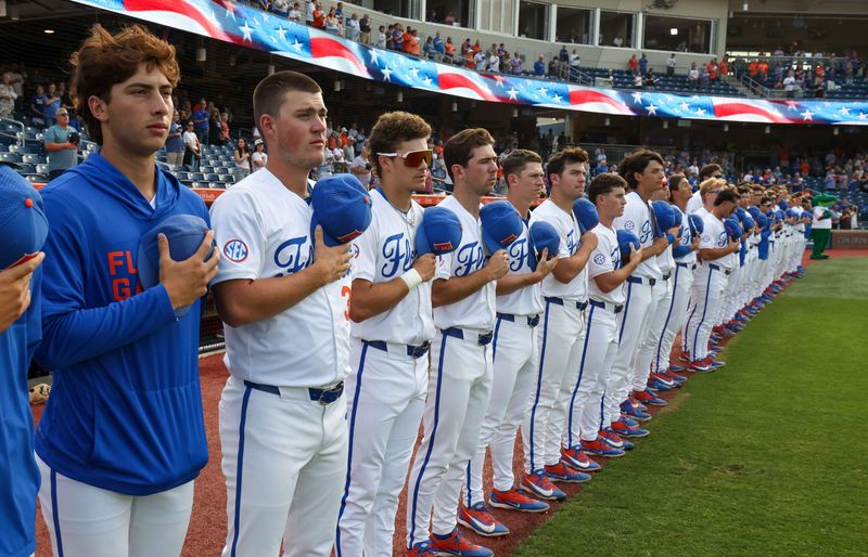 Florida honors the flag before an NCAA baseball game at Condron Family Ballpark at Alfred A. McKethan Field in Gainesville, FL on Friday, April 24, 2026. [Alan Youngblood/Gainesville Sun]