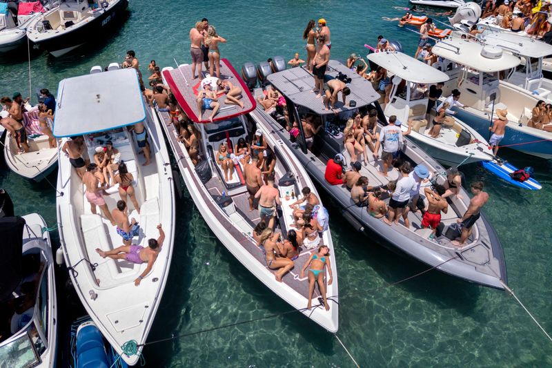 People enjoy Boca Bash on Lake Boca on April 26, 2026, in Boca Raton, Florida. Hundreds of party-goers floated on the lakes in boats, kayaks and paddle boards.