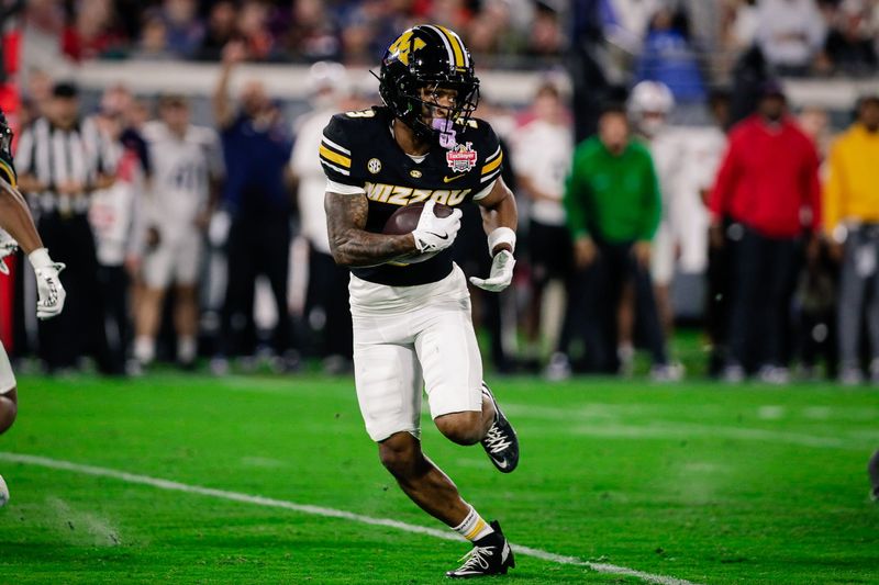 Dec 27, 2025; Jacksonville, FL, USA; Missouri Tigers wide receiver Kevin Coleman Jr. (3) runs the ball against the Virginia Cavaliers during the third quarter at EverBank Stadium. Mandatory Credit: Travis Register-Imagn Images