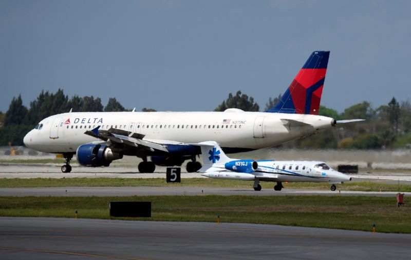 A Global Jetcare plane and a Delta Airlines jet taxi on runways at Palm Beach International Airport on March 12, 2026, in West Palm Beach, Florida.